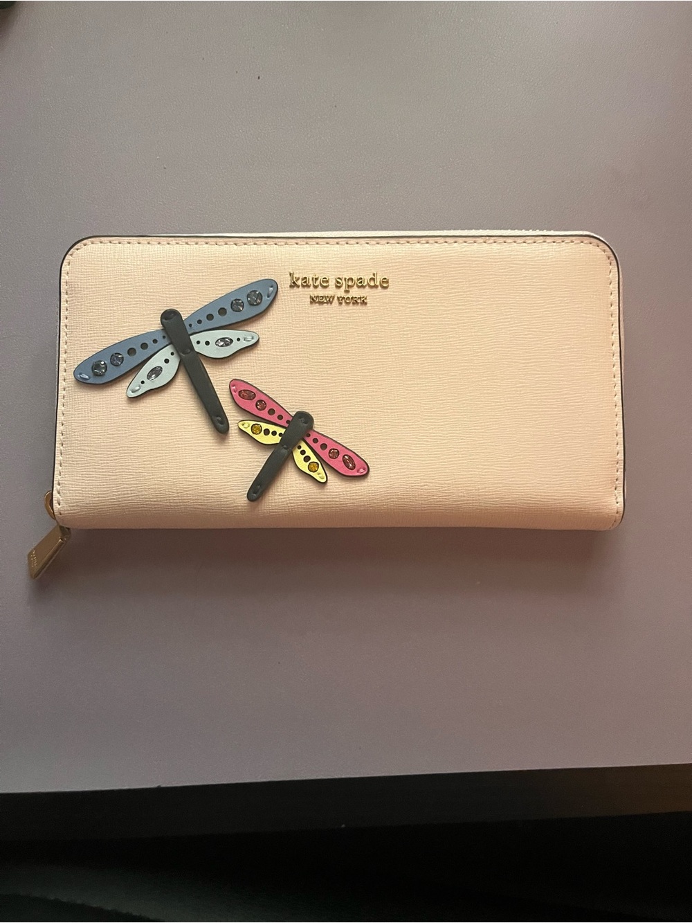 Kate Spade continental wallet with embellished dragonfly appliqués